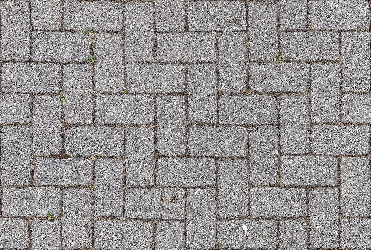 Close-up of interlocking gray brick pavement. Ideal for urban, texture, and construction themes.